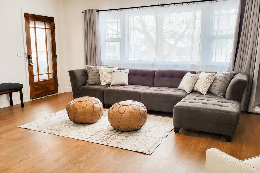 a living room with a couch and two spheres on the floor at Cozy and Spacious Home in Ogden in Ogden