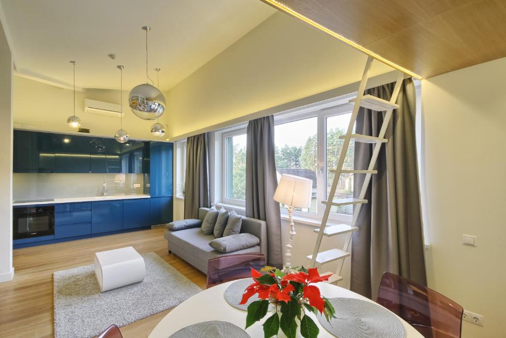 sala de estar con escalera y cocina en Apartamentai Aqua, en Druskininkai