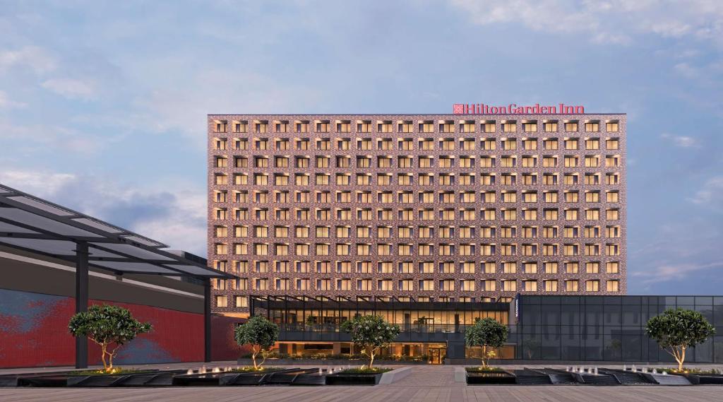 a large building with a lot of windows at Hilton Garden Inn Bengaluru Embassy Manyata Business Park in Bangalore