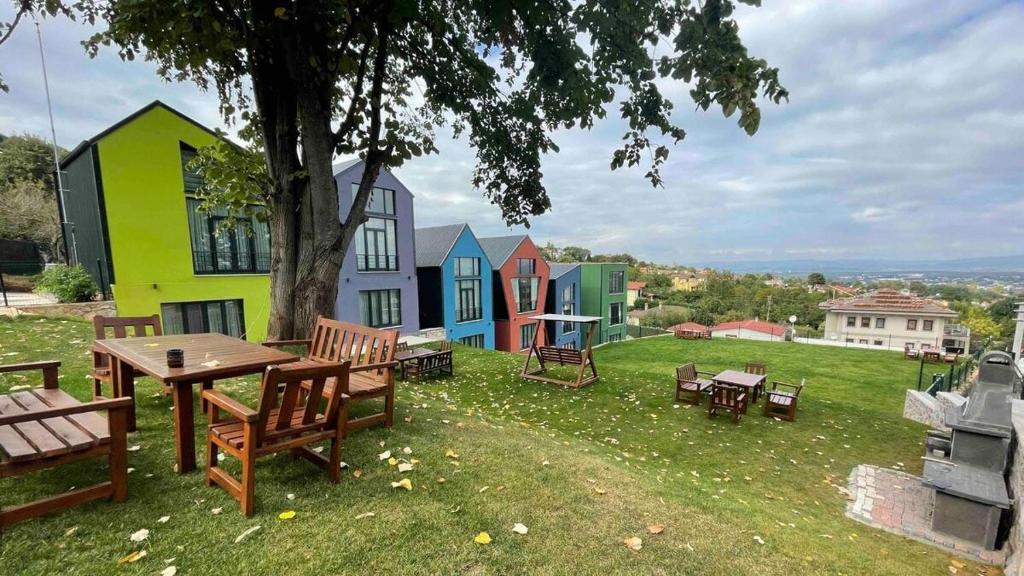 a group of colorful houses with a table and benches at MYDN GROUP KONUK EVİ in Göktürk
