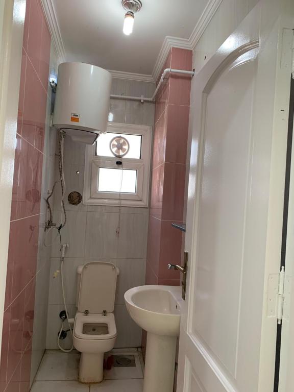 a small bathroom with a toilet and a sink at شقة فندقية فاخرة luxury apartment sea view in Alexandria