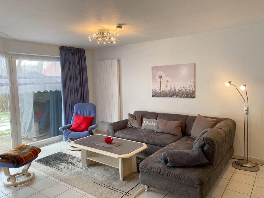 a living room with a couch and a table at Haus-Am-Sommerdeich-Whg-12 in Sankt Peter-Ording