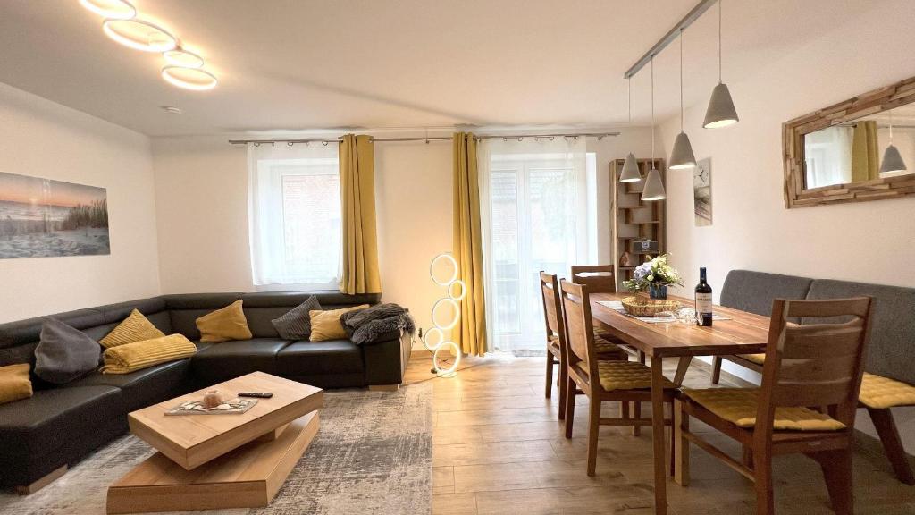 a living room with a couch and a table at Duenenhuus in Sankt Peter-Ording