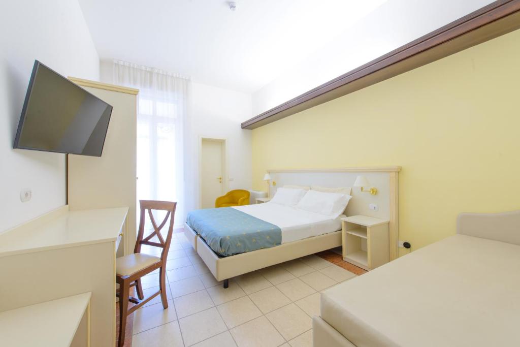 A bed or beds in a room at Palace Hotel Domus Mea Riccione