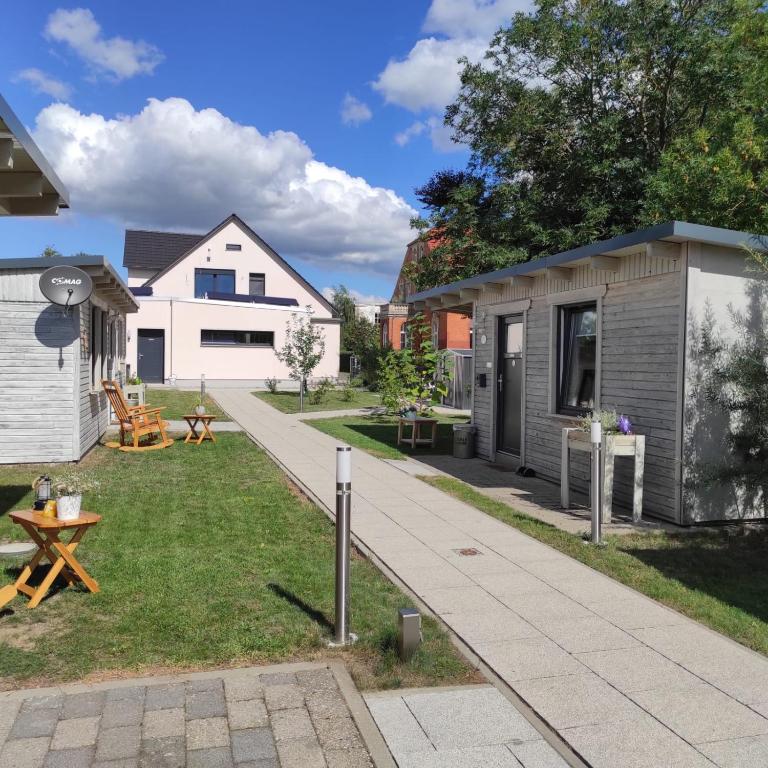 a backyard with a tiny house and a patio at La Maison Pritzwalk - Bett & Bike in Pritzwalk