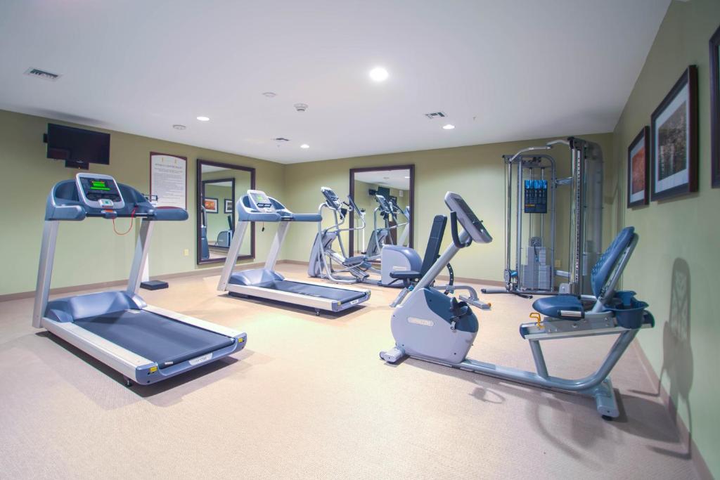 a gym with several tread machines in a room at Staybridge Suites Denver - Central Park, an IHG Hotel in Denver