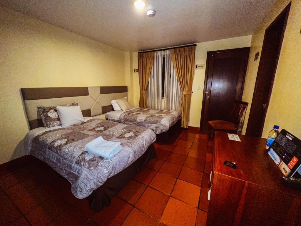 Postel nebo postele na pokoji v ubytování Hotel Casa Kolping Quito