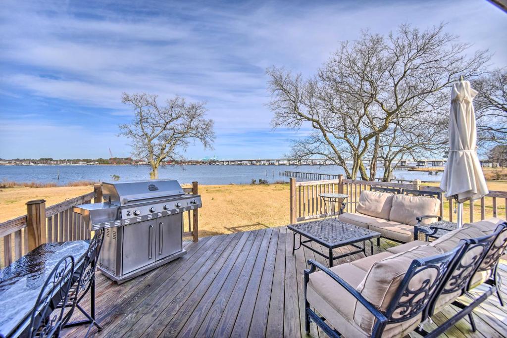 a deck with a grill and chairs and a couch at Portsmouth Waterfront Vacation Rental with Deck in Portsmouth