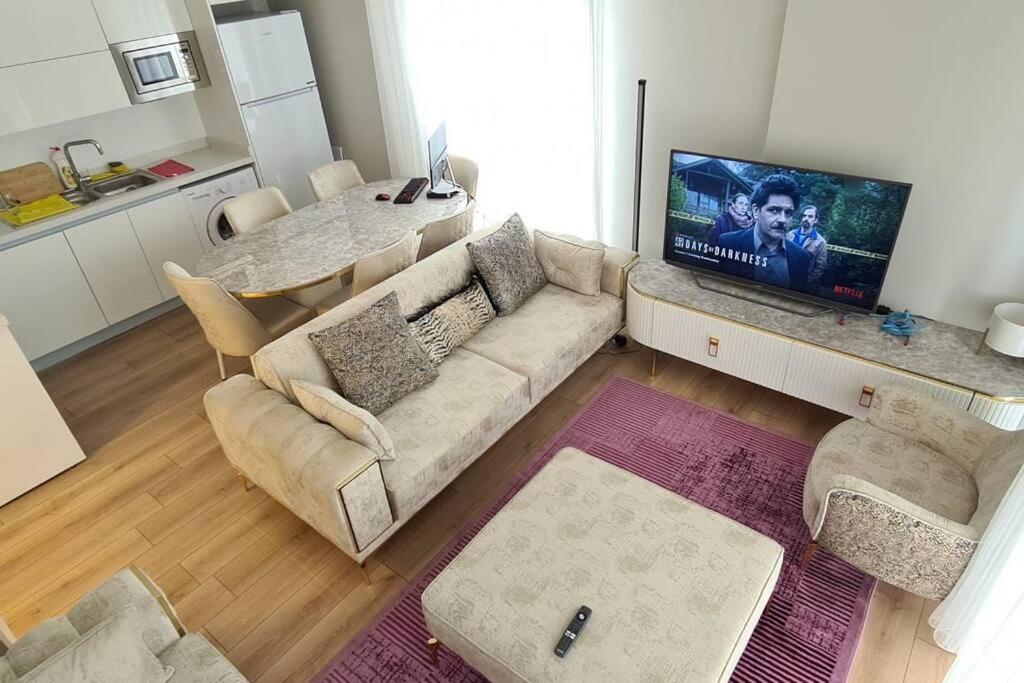 a living room with a couch and a tv in it at 2bedrooms 2washrooms with parking. near Starbucks in Istanbul