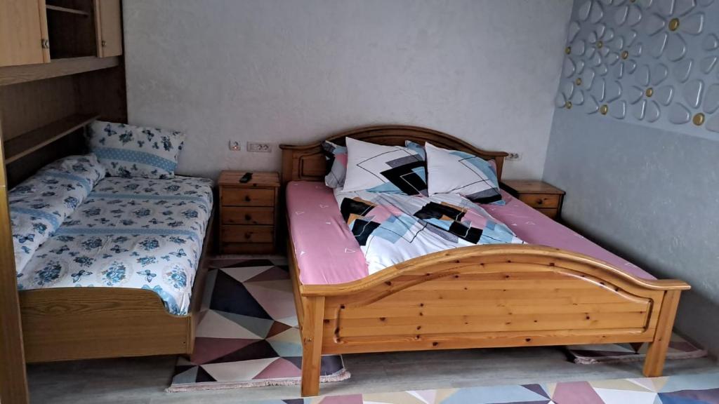 a bedroom with a twin bed with a wooden frame at Casa Luna in Gura Humorului