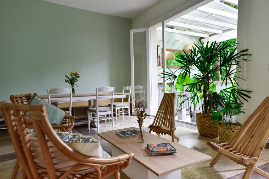 a living room with rocking chairs and a table at Casa Caravan - Plant Based Concept House in Buenos Aires