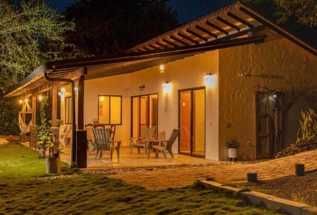 a small house with a patio at night at Cabaña Capella in Pinchote