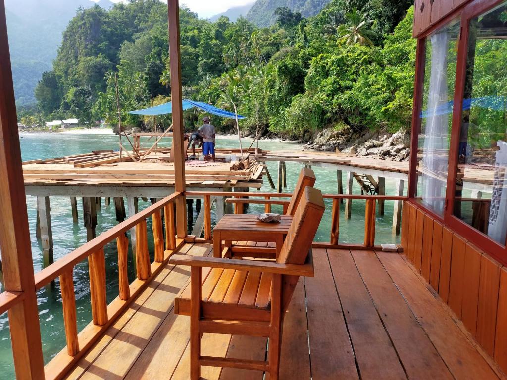 a wooden deck with a table and chairs on a boat at Bellarizki Resort in Seleman