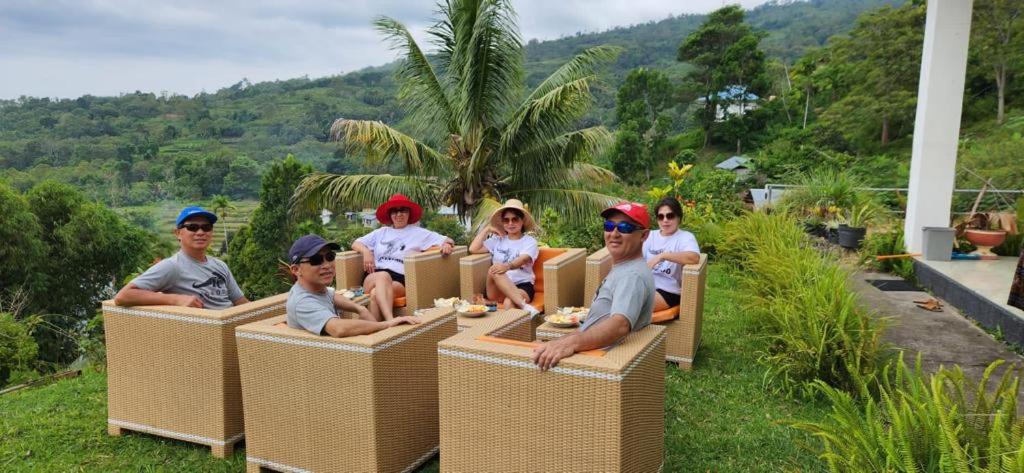 a group of children riding on a train at jaya hill garden in Kelimutu