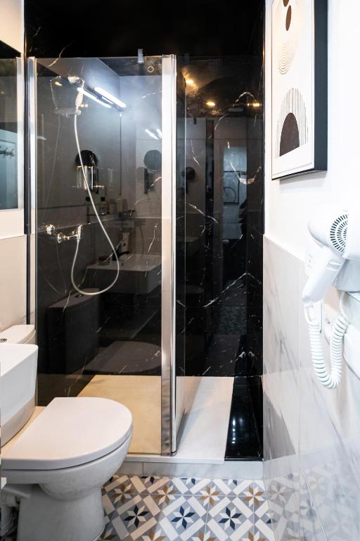 a bathroom with a toilet and a shower at Apartments WS Tour Eiffel - Laos in Paris