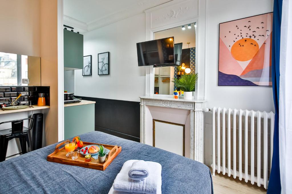 a room with a bed with a tray of food on it at Apartments WS Tour Eiffel - Laos in Paris