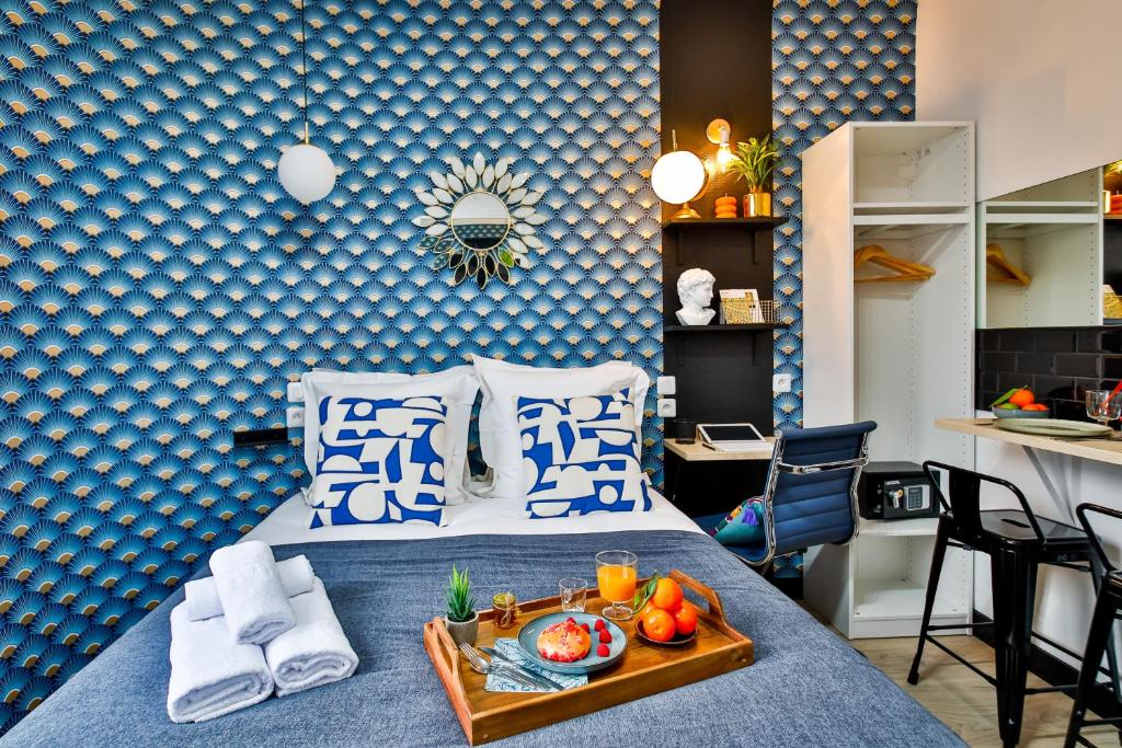 a bedroom with a bed with a tray of food on it at Apartments WS Tour Eiffel - Laos in Paris
