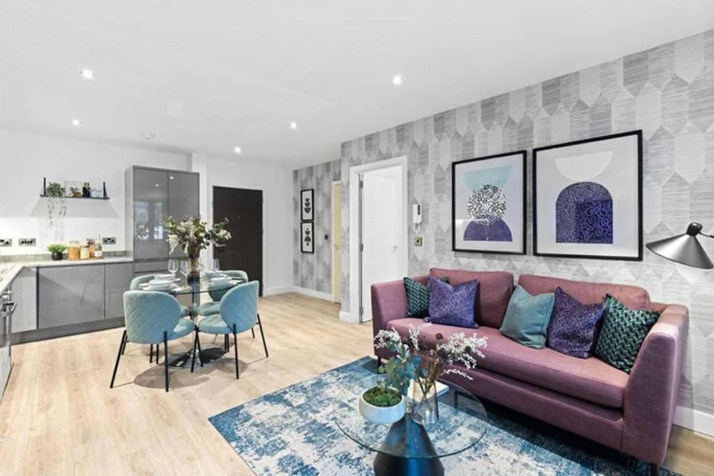 a living room with a purple couch and a table at Luxury Modern, One bedroom Flat in Olton