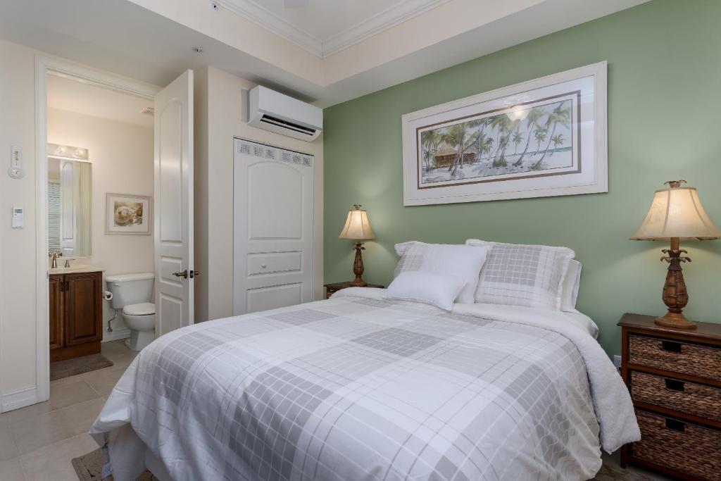 a bedroom with a white bed and a bathroom at -The Bonita Paddle Efficiency- Your Home Away From Home in Paradise condo in Bonita Springs