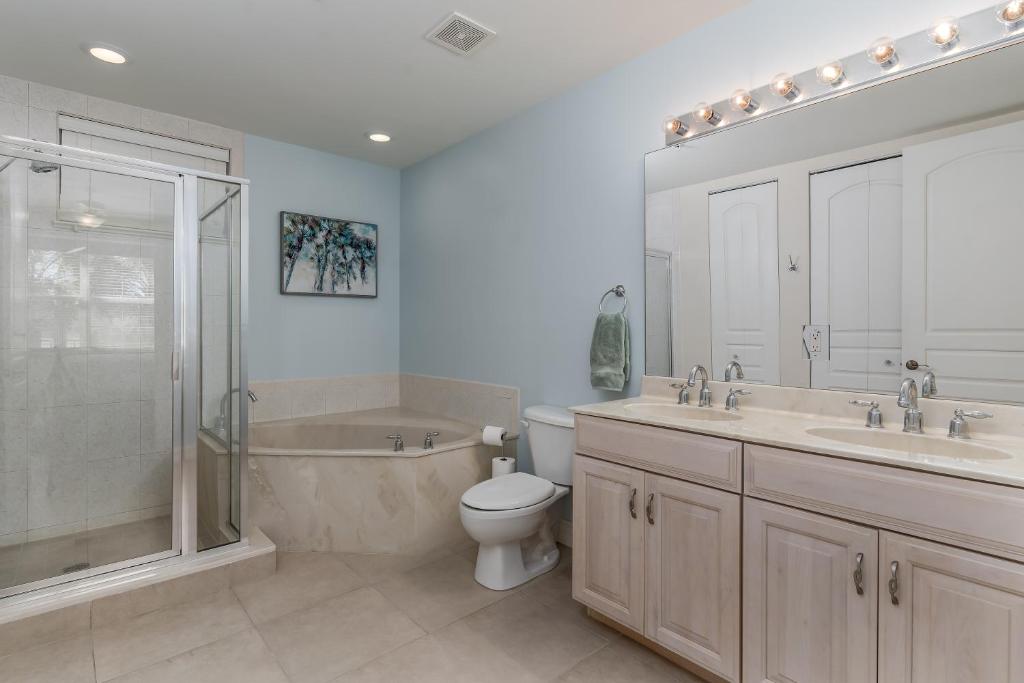 a bathroom with a toilet and a sink and a shower at - The Bonita Paddle A202 - Beautiful Bonita Springs Condo with Mother In Law Suite! condo in Bonita Springs