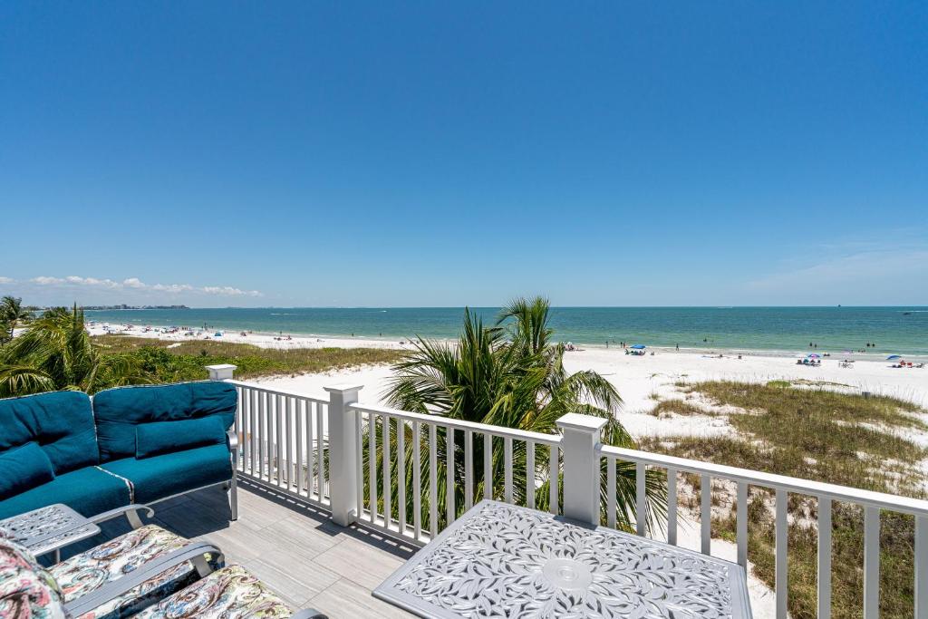 a balcony with a view of the beach at Luxury Beach Front Pool Home in Paradise! home in Fort Myers Beach