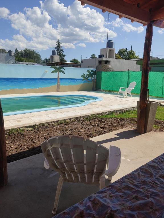a chair sitting in front of a swimming pool at Cabañas Los Materos in Santa María