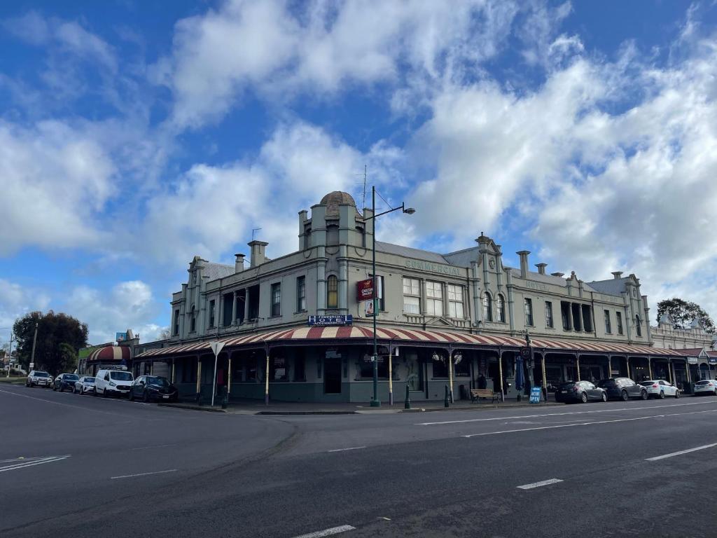 a large white building on the corner of a street at Commercial Hotel Camperdown in Camperdown