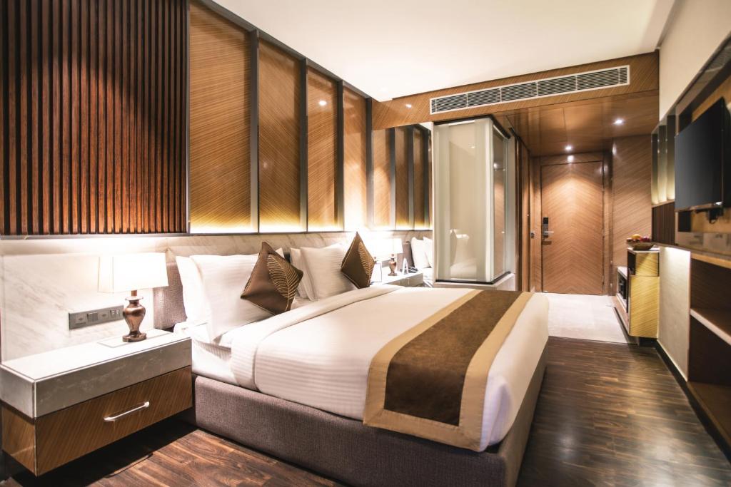 a bedroom with a large bed in a room at Amritara Kirpa, Amritsar Golden Temple in Amritsar