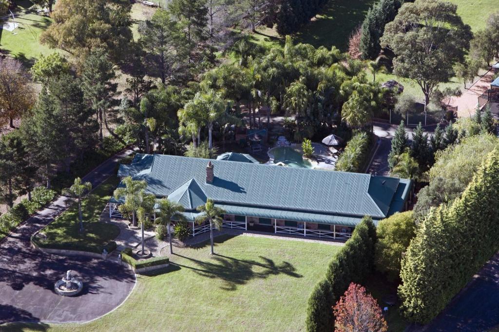 an overhead view of a house with a blue roof at Relaxin in Dural