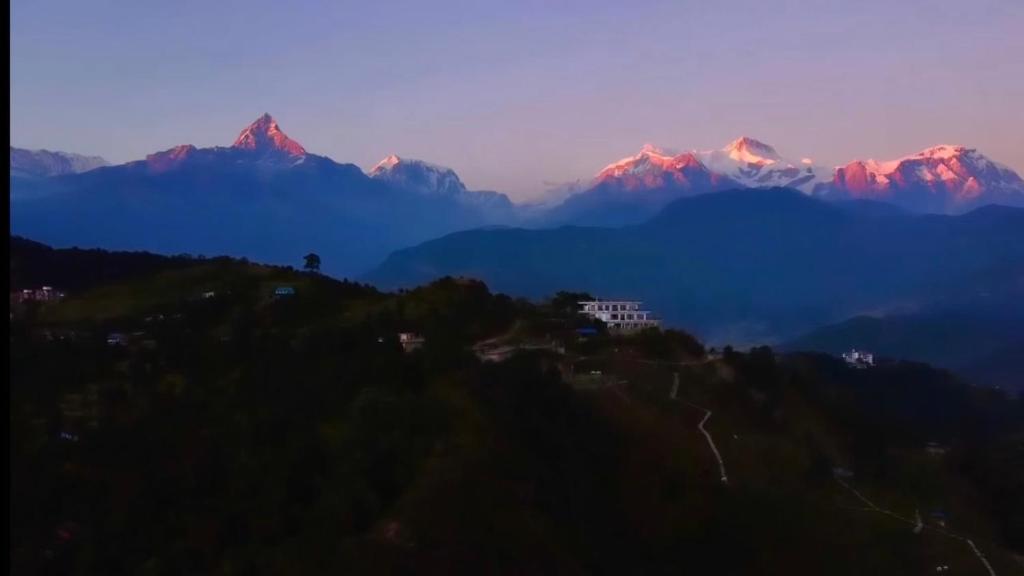 a view of a mountain range with mountains in the background at Hotel Pokharaeye in Pokhara