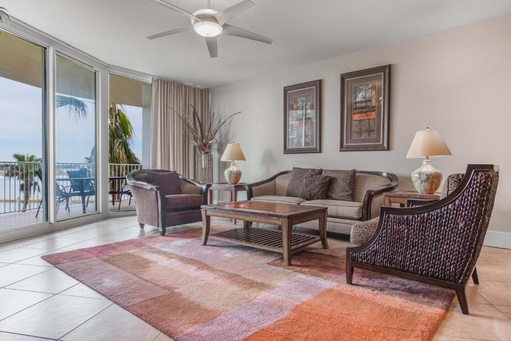 a living room with a couch and chairs and a table at Caribe Resort Unit C201 in Romar Beach