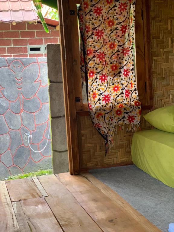 a door to a room with a curtain on it at Tetebatu Sama Sama Bungalows in Tetebatu