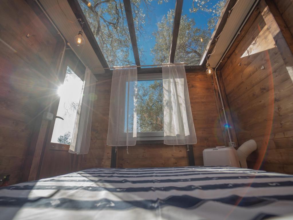 a bedroom with a large window and a bed at Agriturismo S.Ilario in Genoa
