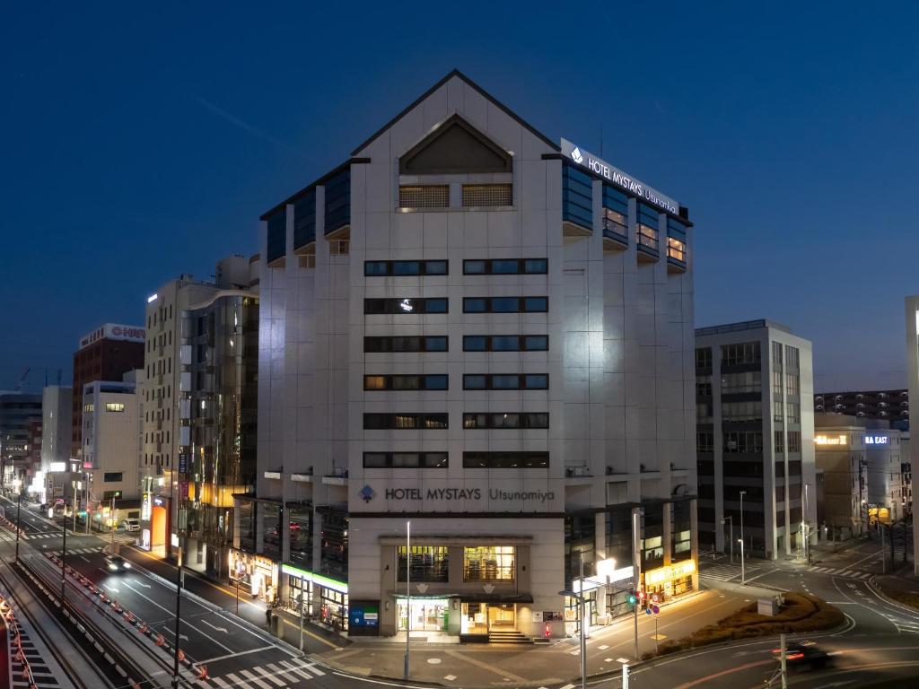 a large building in a city at night at HOTEL MYSTAYS Utsunomiya in Utsunomiya