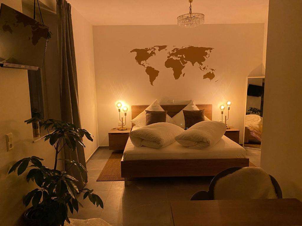 a bedroom with a bed with a world map on the wall at Jakobshof in Bad Mergentheim
