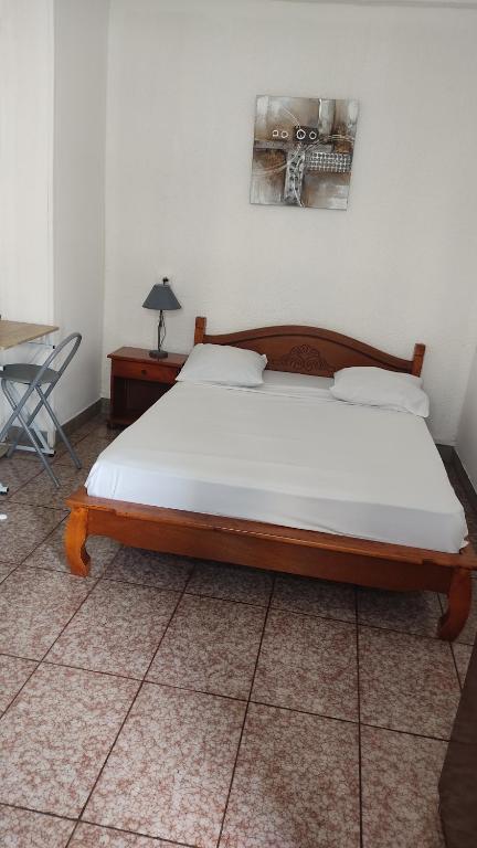 Postel nebo postele na pokoji v ubytování Hôtel Le Nathania