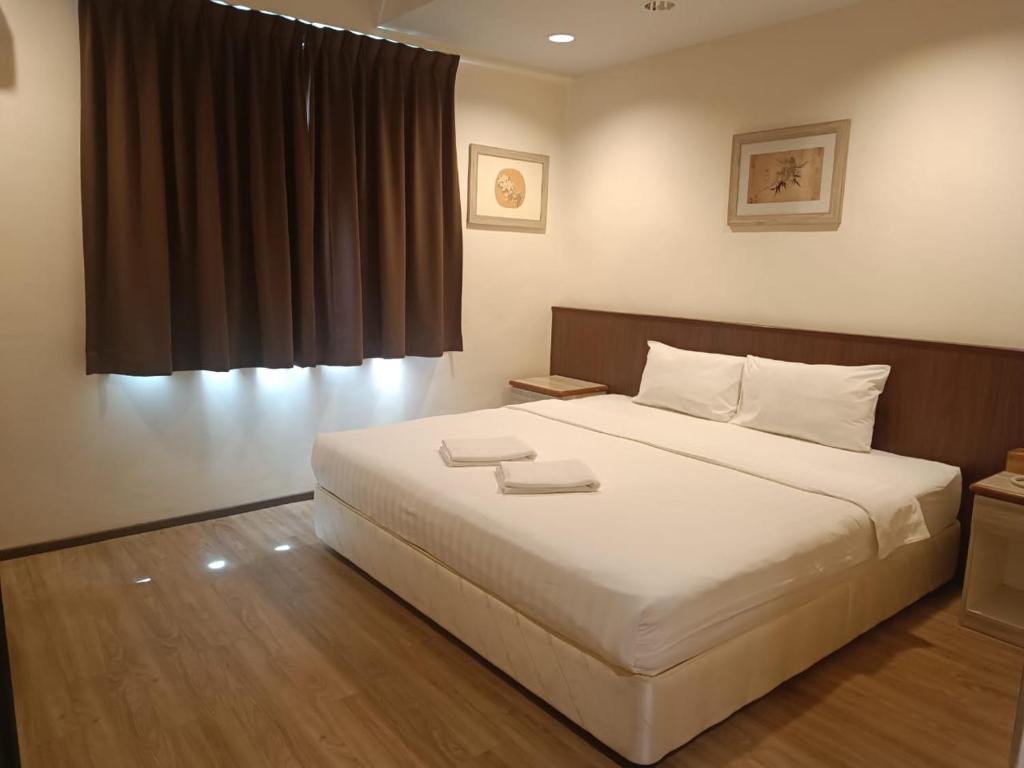 Postel nebo postele na pokoji v ubytování AMB LAI LAI HOTEL