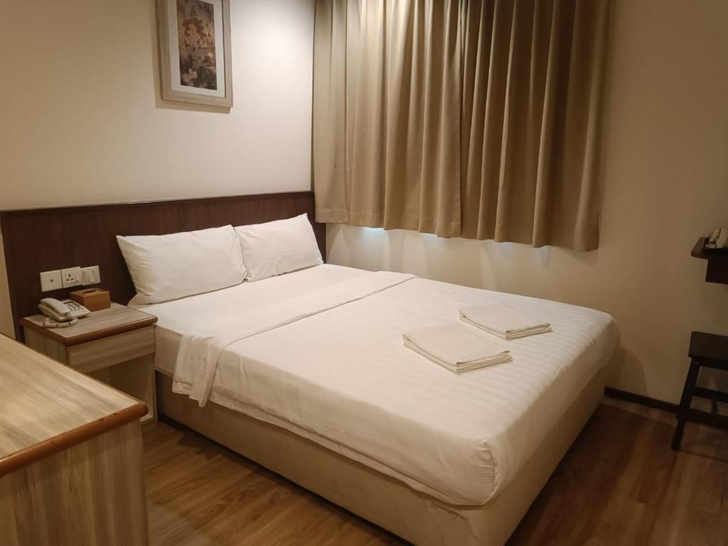 Postel nebo postele na pokoji v ubytování AMB LAI LAI HOTEL