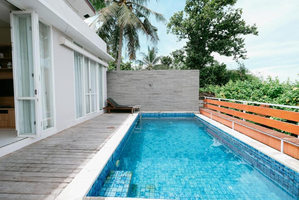 a swimming pool in the backyard of a house at The Lavana River Villas Lombok in Senggigi