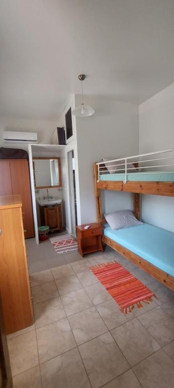 a room with two bunk beds and a bathroom at "STELIOS & GALINI" in Symi