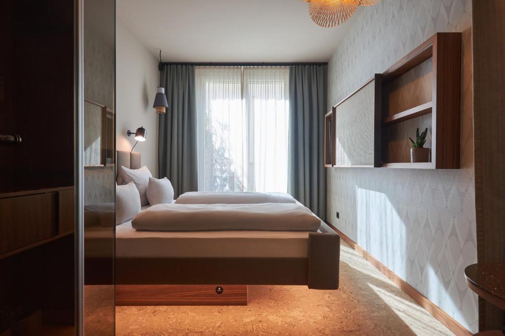 Postel nebo postele na pokoji v ubytování Cocoon Sendlinger Tor