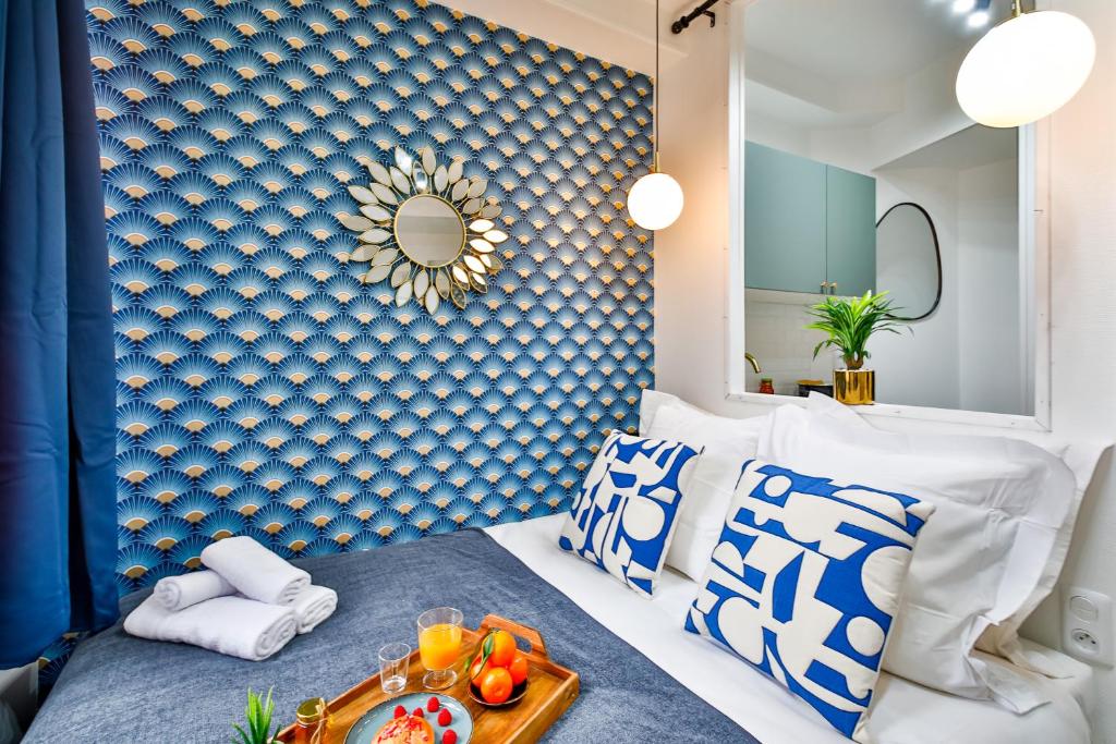 a bedroom with a blue and white wall at Apartments WS Tour Eiffel - Laos in Paris