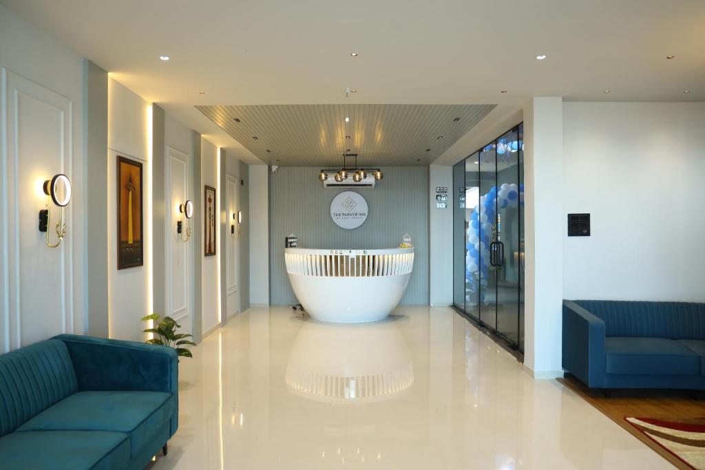 a lobby with a large tub in the middle of a room at HOTEL THE PARKER INN By KBNT GROUP in Surat