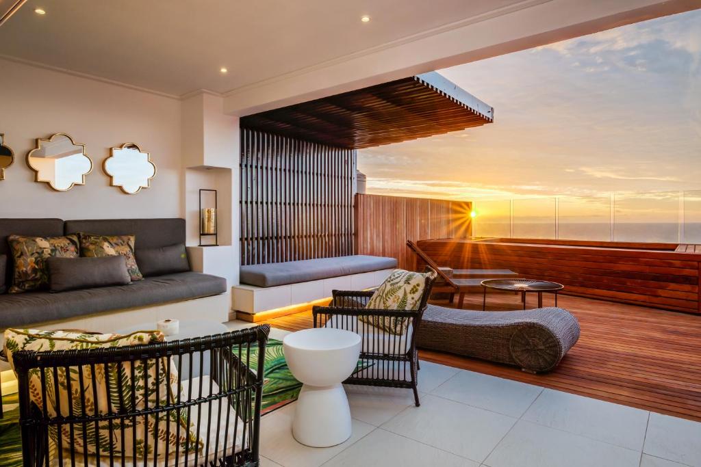 a living room with a couch and a table at Malibu in Cape Town