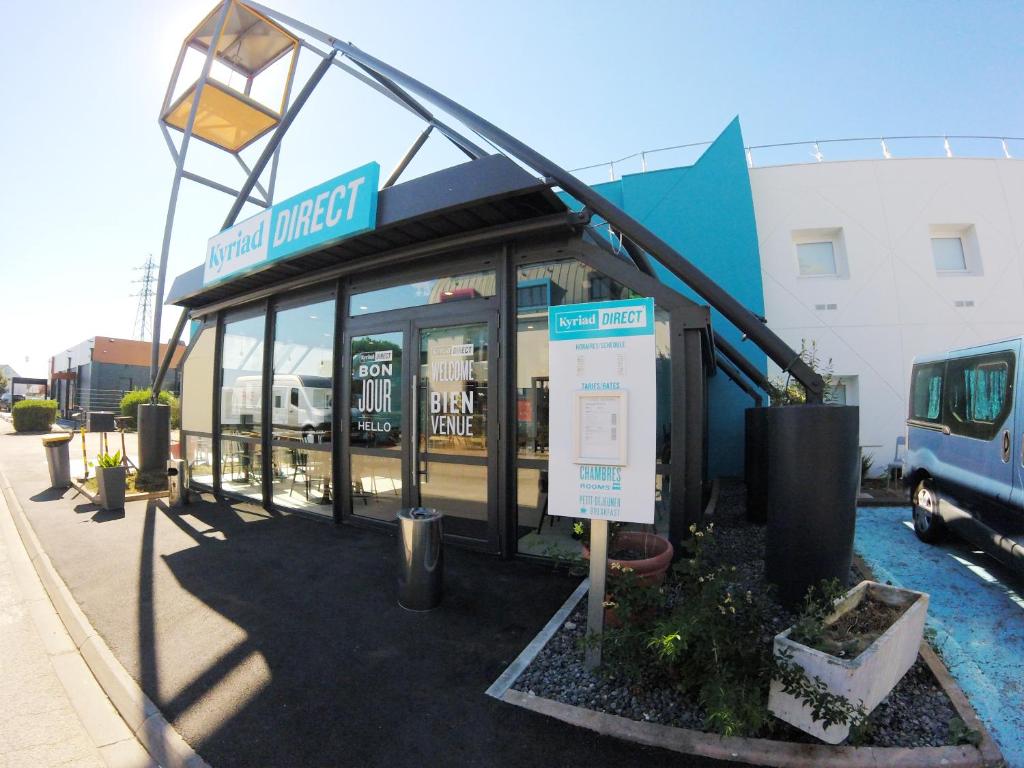 a store front with a sign in front of it at Kyriad Direct Dijon Sud - Chenove in Chenôve