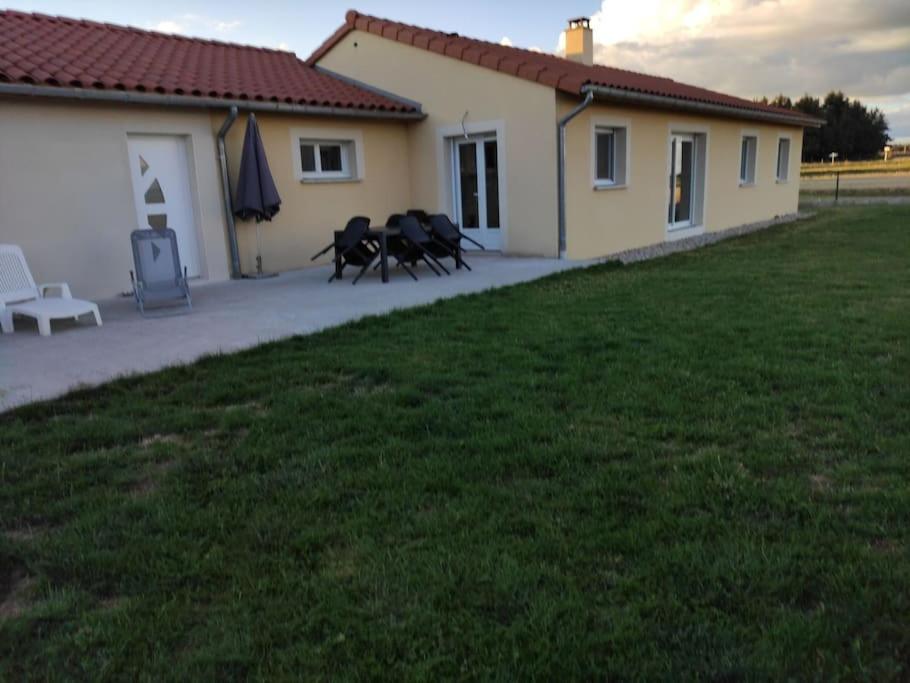 a house with three horses in front of a yard at Maison entière de plein pied avec vue panoramique. in Venteuges