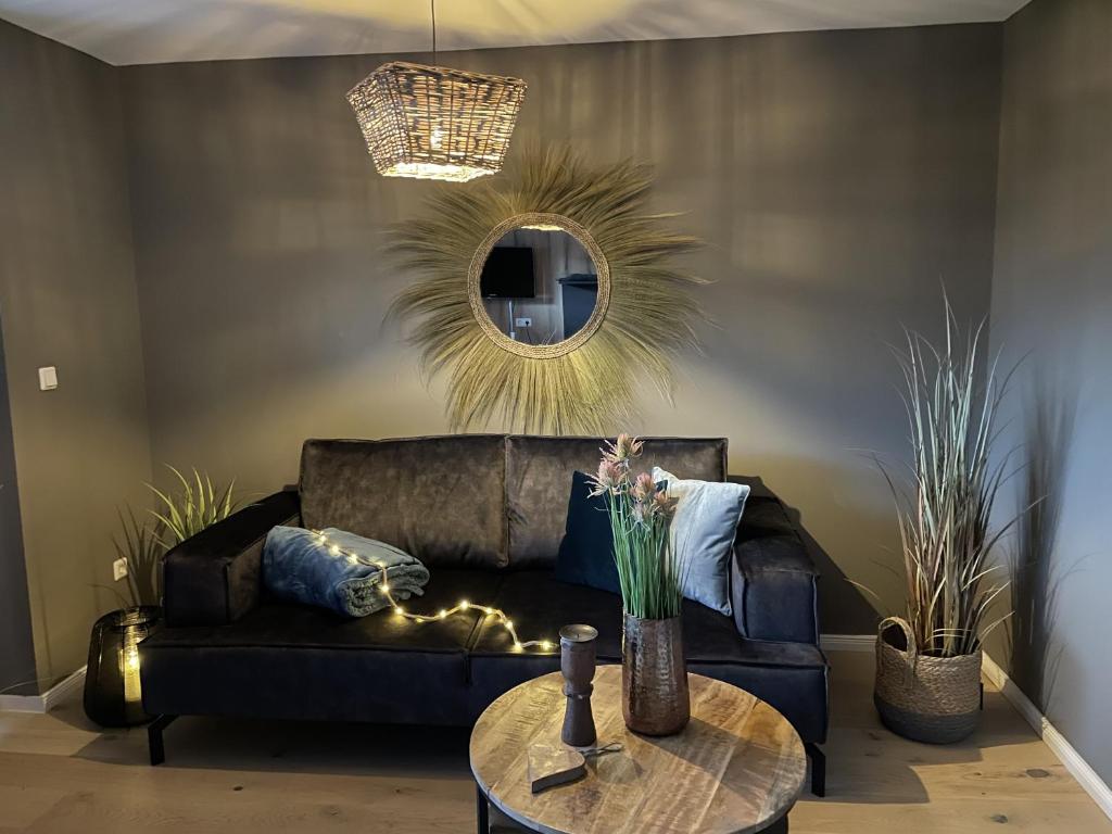 a living room with a couch and a table at Gästehaus Wind und Meer in Norddeich