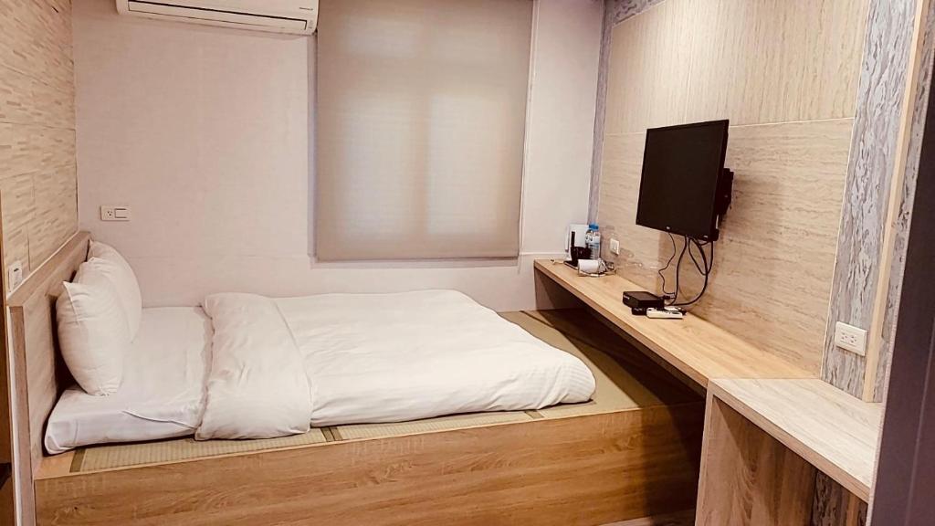 Postel nebo postele na pokoji v ubytování Beauty Garden Hotel - Jiaoxi