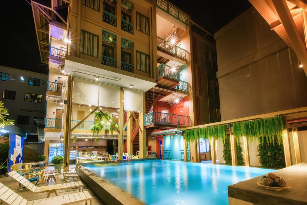 a large swimming pool in the middle of a building at Lub d Cambodia Siem Reap in Siem Reap