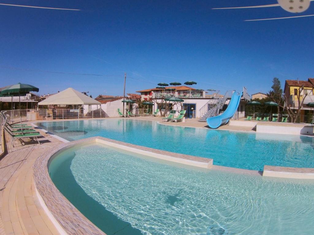 a swimming pool with a slide in a resort at Lianna Beach Resort in Marina di Montenero